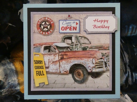 Rusty old cars in garage by Karen Glumm