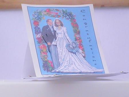 Wedding Couple in Floral Arch by Katrina Oldham