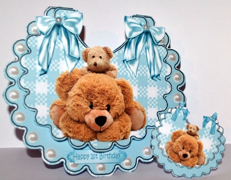 Lovely Cuddly bears on a gingham bib with blue bows by Kristina Norbat