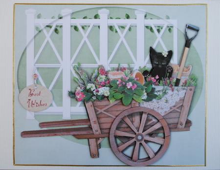 Cat in a Wheelbarrow Full of Flowers by Kristina Norbat