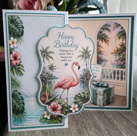 Tropical Flamingo Birthday Card Front – Exotic Flowers, Sunset Ocean View & Island Design by Kym Barry