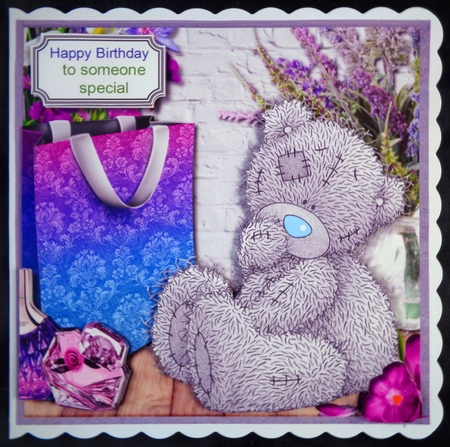 Tatty teddy surrounded by lilac and purple accessories by Linda Short