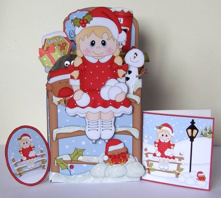 3D Christmas Rubber Band Pop Up Box Card - Cute Little Skating Girl has a Snowball fight by Margaret McCartney