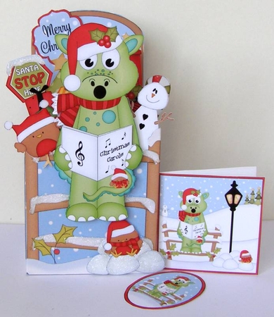 3D Christmas Rubber Band Pop Up Box Card - Little Christmas Dennis Dinosaur goes Carol Singing by Margaret McCartney