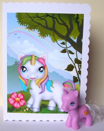 Gorgeous little rainbow unicorn in the meadow with rainbow A4 by Margaret McCartney