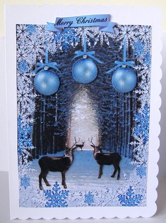 Snow covered tree tunnel and deer in snowflake frame with baubles by Margaret McCartney