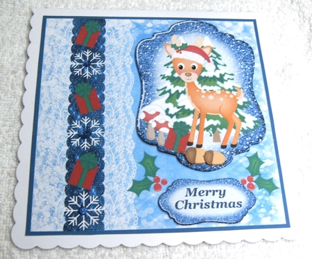 Blue Christmas present deer card front by Margaret Scott