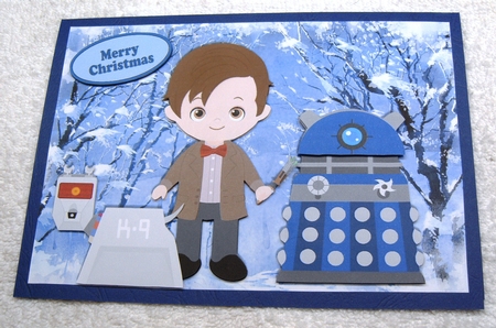 Dr Who and his canine friend with a dalek in winter by Margaret Scott