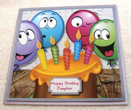 Five candle cake with funny face balloons by Margaret Scott