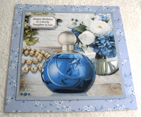 Blue perfume, flowers and gold beads by Margaret Scott