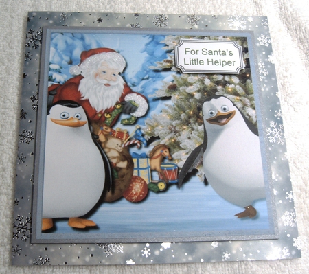 Madagascan penguins and santa on ice pond by Margaret Scott