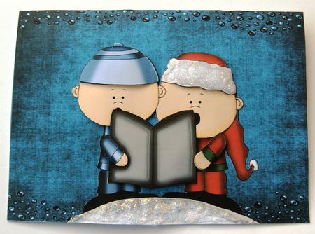 Two Christmas Singers on Dark Blue Backing Paper by Margaret Scott