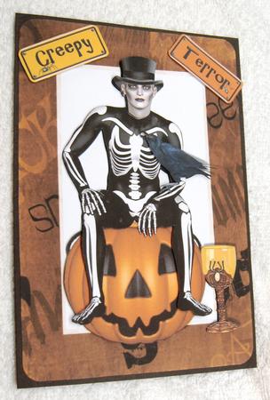 Skelly Man Sitting on Pumpkin with Crow by Margaret Scott