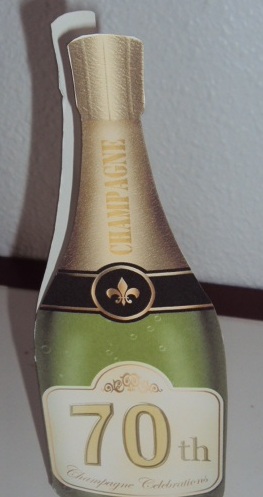 Large Dl 70th Champagne Bottle Shaped Card by Margaret Swaby