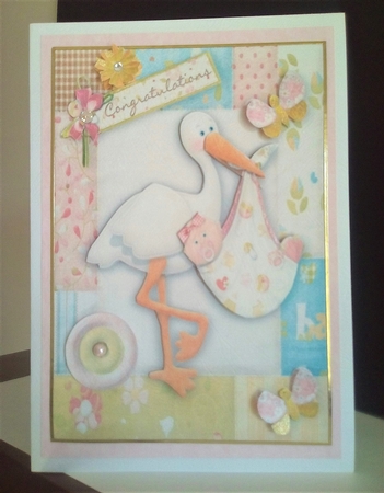 Sweet Baby Girl with Stork in Flower Frame by Margaret Swann