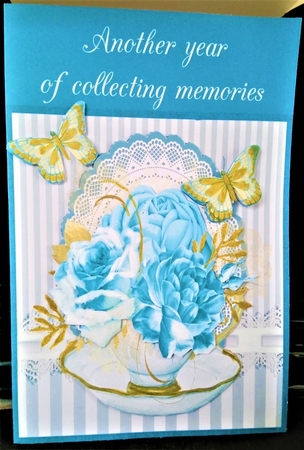 Cup of blue roses by Margarette Blakeborough