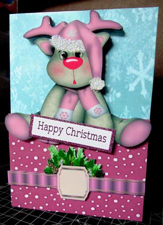 Baby Reindeer in Pink Santa Hat & Bow Over the Edge by Margarette Blakeborough
