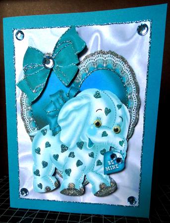 Turq Elephant on Frill Heart with Bow by Margarette Blakeborough