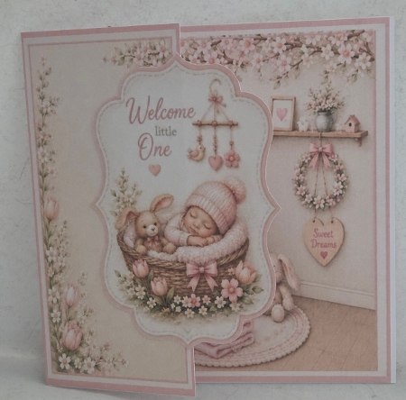 Welcome Little One Baby Girl Card Front – Pink Pastel Newborn Basket & Bunny Design by Marion Harding