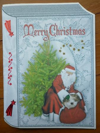 Santa with His Presents on a Folded Book by Marion West