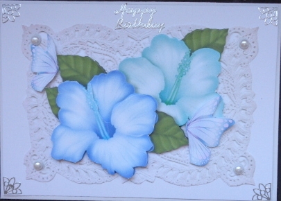 Pretty tropical blue shades flowers on vintage lace with pearls by Mary Murphy