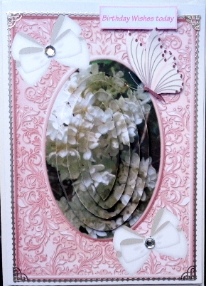 White flowers in pink ornate frame  with bows and butterflies oval pyramids by Mary Murphy