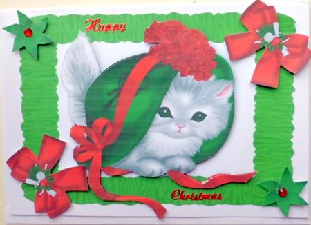 Little Kitty in Green and Red Bonnet in Frill Frame by Mary Murphy