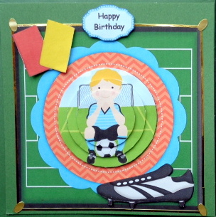 Boy Sitting on a Football Circle Pyramid by Mary Murphy