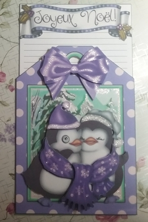 Lovely cuddle penguins with spot tag and purple bow topper by Misha Saillant