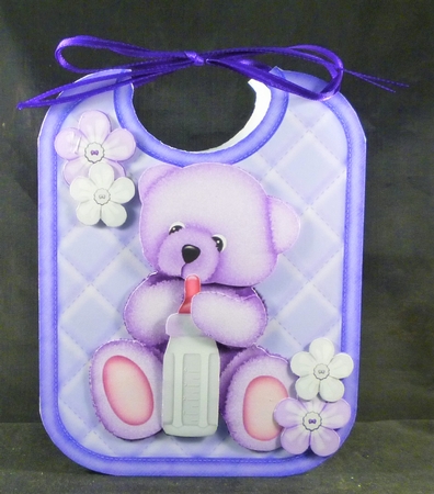 Cute cuddle bear on lilac babys bib with bottle by Michelle Chivers
