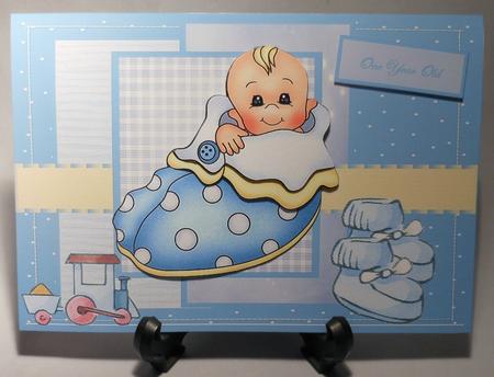 Baby Boy in a Slipper Bed Card Front by Michelle Chivers