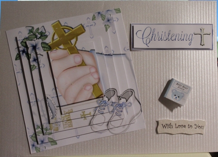 Hand Holding Cross with Bible and Blue Baby Shoes Pyramids by Moira Paterson  (Ornella)