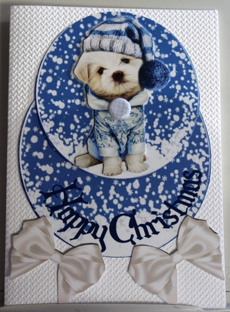 Lovely puppy in blue snow rocker with bows by Moira Paterson  (Ornella)