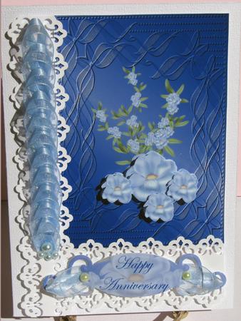 Pale Blue Flowers on Sapphire Embossed Background by Nancy Boatwright