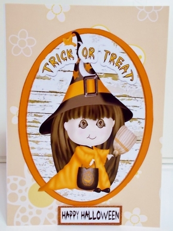 Two Halloween toppers of a witch and a ghost (orange) by Pam Stubley