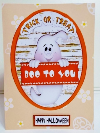 Two Halloween toppers of a witch and a ghost (orange) by Pam Stubley