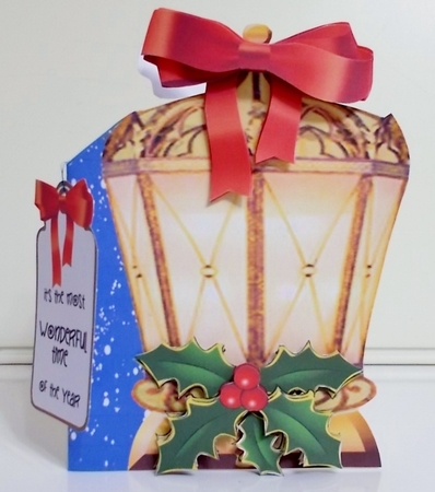 Gold lantern with holly  by Pam Stubley