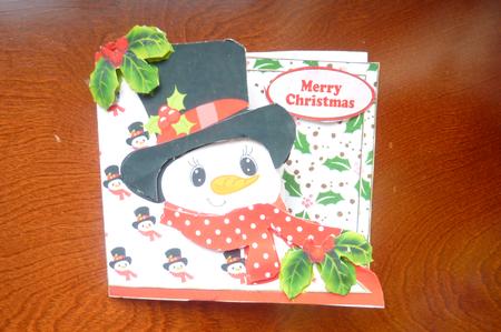 Snowman with Holly in His Top Hat Over the Edge by Rosina Walker