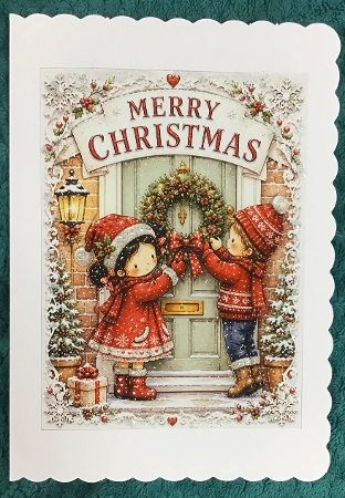 lucy and george hanging the door wreath by Sharron Hylton