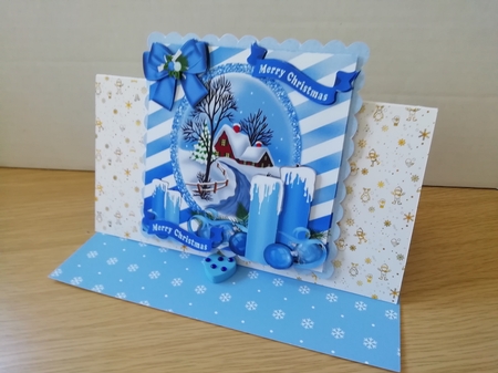 pretty blue candles with bow and cottage with snow 8x8 by Stephanie Bardelli