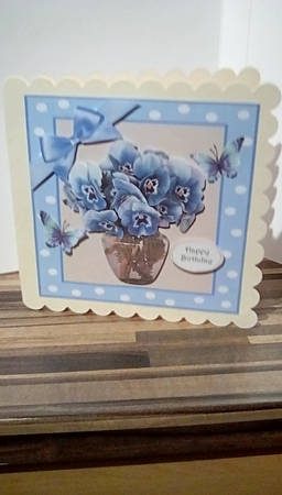 Pretty blue pansies in a vase in 7x7 polkadot frame by Susan Lapornik