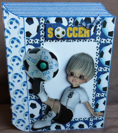 Boy Sitting Down Playing Footie in Blue Folded Book by Susan Powell-Barton