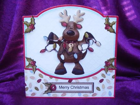 Rudolph Putting Up the Lights Shaped Quick Card by Susan van Dijk