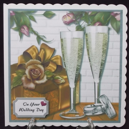 Anniversary or wedding card with champagne, roses, gift box and a set of wedding rings by Suzi Cooper