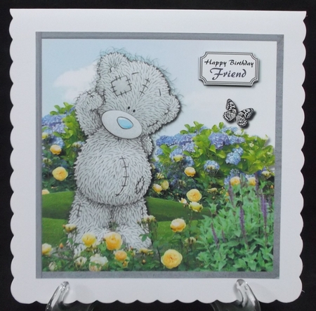 Tatty teddy in flower garden by Suzi Cooper