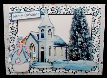 Church in the Snow with Snowman in Blue Star Frame by Suzi Cooper