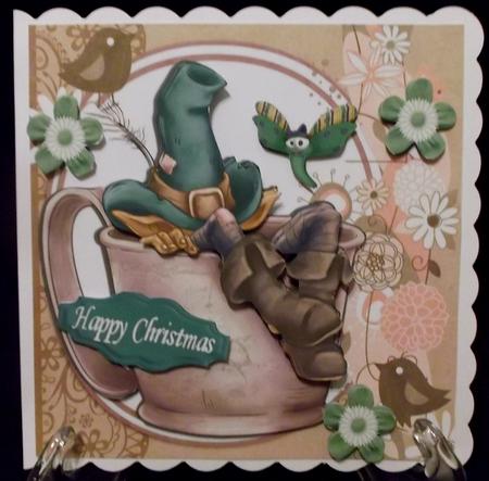 Gnome in Green Hat Taking a Nap in a Teacup by Suzi Cooper