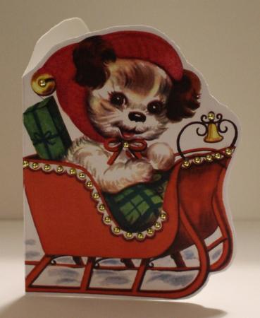 Christmas Dog in Sleigh by Taina Kankare