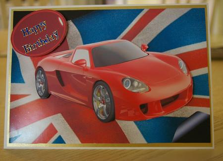 Red Sports Car on the Union Jack Flag by Tracey Duckmanton