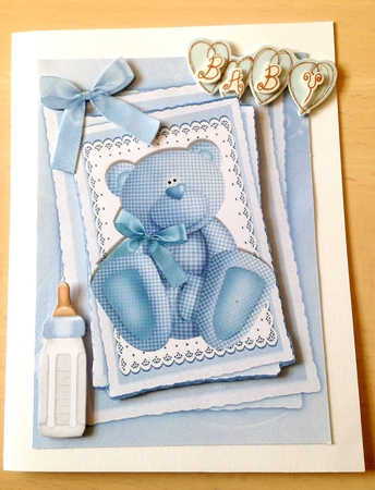 Cute little blue gingham bear with bow on lace stacker by Ulla Skraedderdal